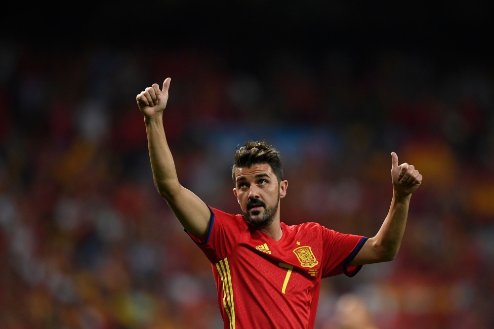 In this file photo taken on Sept. 2, 2017, Spain's forward David Villa waves as he celebrates their victory at the end of the World Cup 2018 qualifier football match Spain vs Italy at the Santiago Bernabeu stadium in Madrid. Star striker Villa, who holds the record for most international goals scored for Spain, announced on Tuesday he was quitting professional football at the end of the season.  — AFP