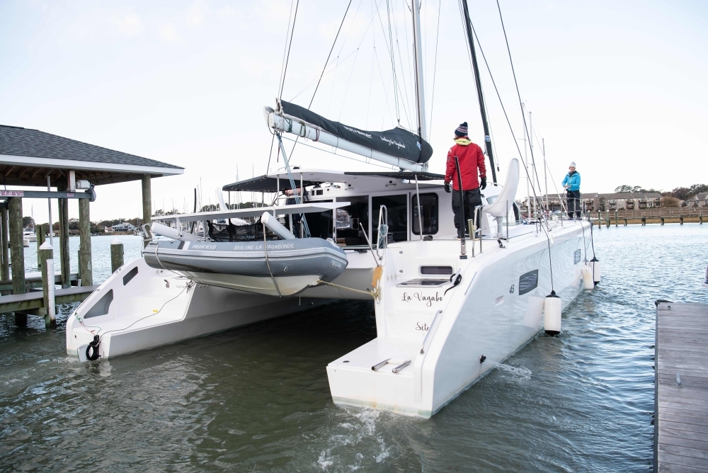 Swedish climate activist Greta Thunberg, center, stands aboard the catamaran La Vagabonde with her father Svante Thunberg, left, La Vagabonde owner Riley Whitelum, second left, and sailor Nikki Henderson, right, as they set sail to Europe in Hampton, Virginia, on Wednesday. — AFP