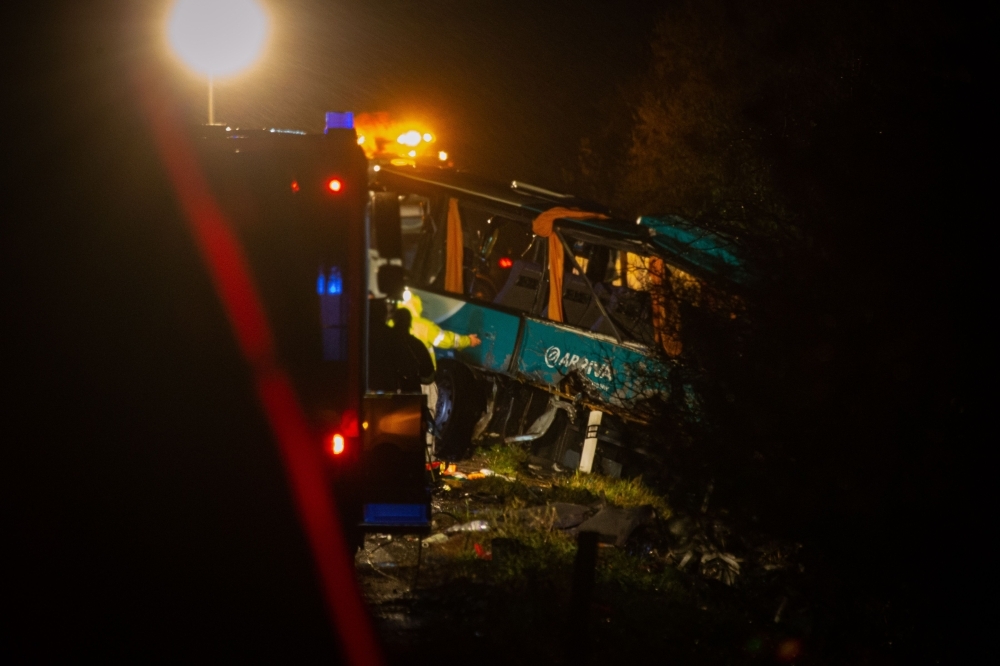 The emergency services work at the scene of collision between a public bus and a truck near the village of Malanta on the outskirts of the city of Nitra, western Slovakia, on Wednesday. — AFP