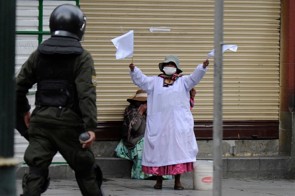 Men are detained by Police Operations Tactical Unit (UTOP) as clashes erupted with supporters of Bolivian ex-President Evo Morales and locals discontented with the political situation during a protest in La Paz on Wednesday. — AFP