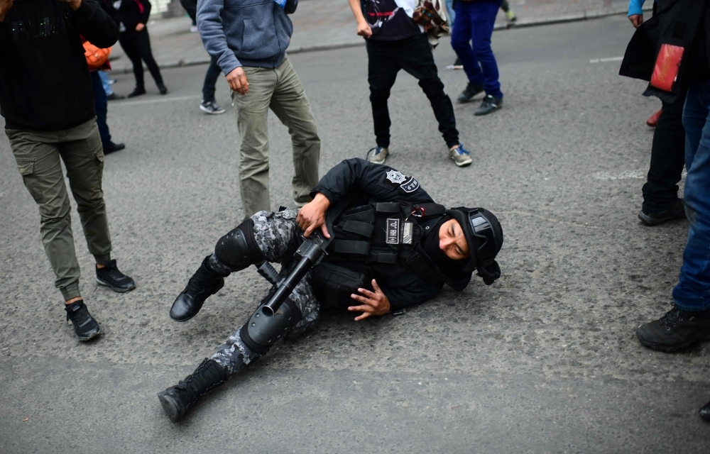 Men are detained by Police Operations Tactical Unit (UTOP) as clashes erupted with supporters of Bolivian ex-President Evo Morales and locals discontented with the political situation during a protest in La Paz on Wednesday. — AFP