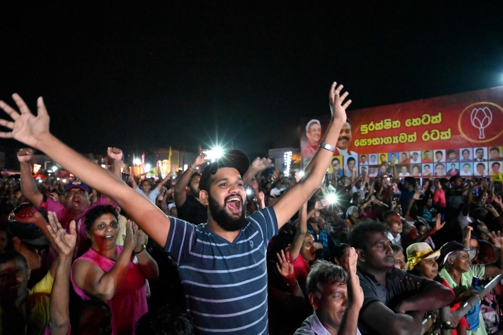 Sri Lanka Podujana Peramuna (SLPP) party presidential candidate Gotabhaya Rajapaksa, second left, and his brother, former Sri Lanka's president Mahinda Rajapaksa, second right, wave at supporters during a campaign rally in Homagama on Wednesday, ahead of the November 16 presidential election. — AFP