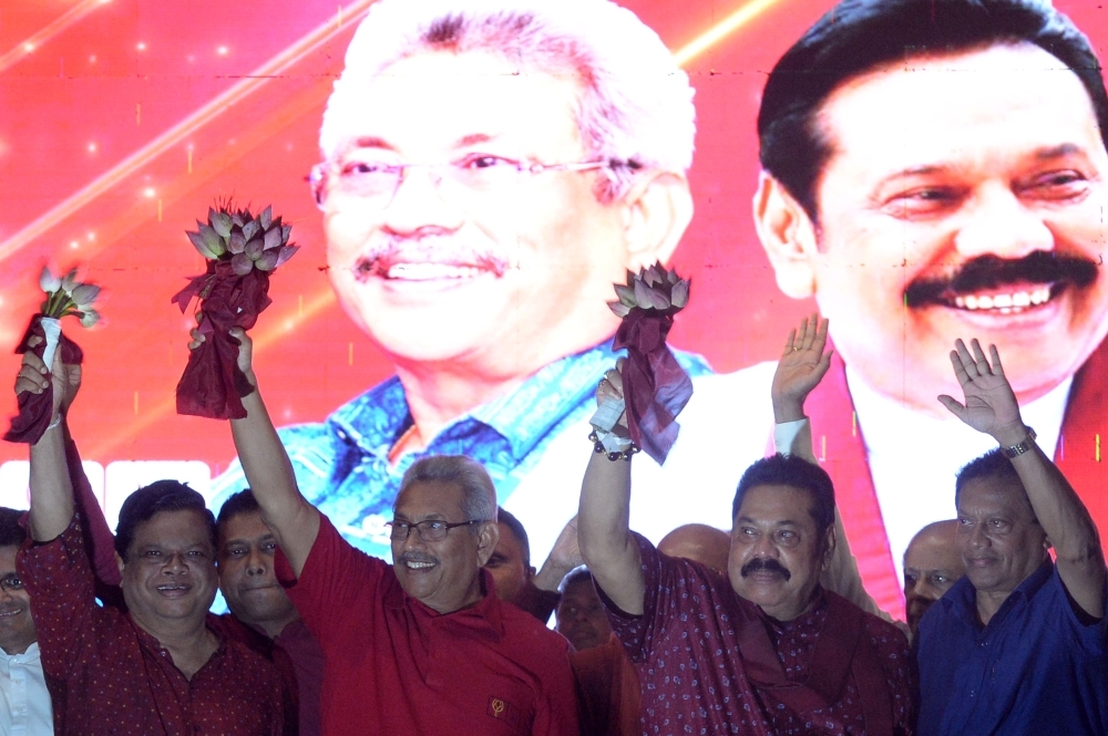 Sri Lanka Podujana Peramuna (SLPP) party presidential candidate Gotabhaya Rajapaksa, second left, and his brother, former Sri Lanka's president Mahinda Rajapaksa, second right, wave at supporters during a campaign rally in Homagama on Wednesday, ahead of the November 16 presidential election. — AFP