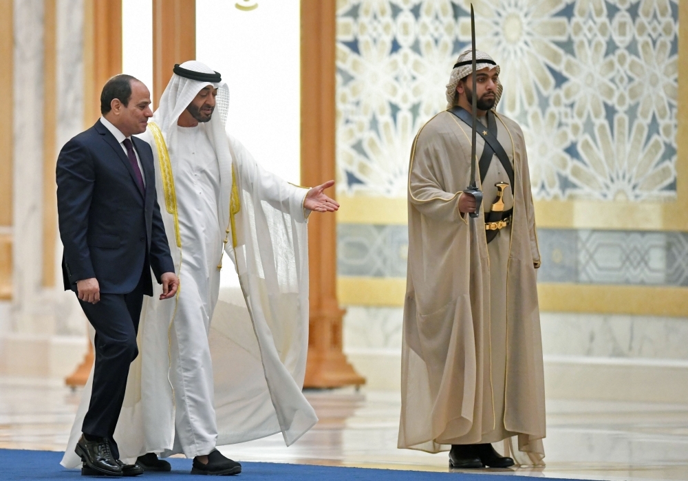 Egyptian President Abdel Fattah El-Sisi and the Crown Prince of Abu Dhabi, Sheikh Mohamed Bin Zayed Al-Nahyan, attend a welcome ceremony in the Emirati capital's Al-Watan presidential palace in Abu Dhabi on Thursday. — AFP