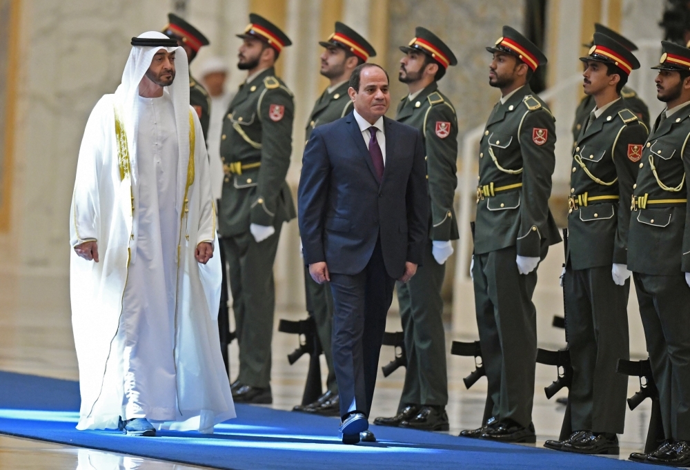 Egyptian President Abdel Fattah El-Sisi and the Crown Prince of Abu Dhabi, Sheikh Mohamed Bin Zayed Al-Nahyan, attend a welcome ceremony in the Emirati capital's Al-Watan presidential palace in Abu Dhabi on Thursday. — AFP