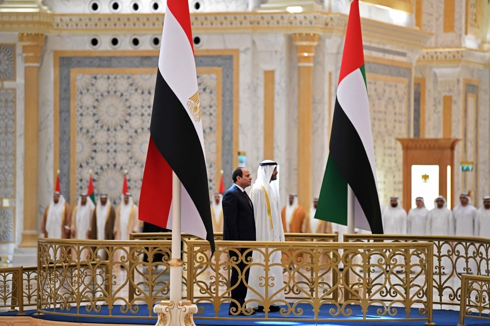 Egyptian President Abdel Fattah El-Sisi and the Crown Prince of Abu Dhabi, Sheikh Mohamed Bin Zayed Al-Nahyan, attend a welcome ceremony in the Emirati capital's Al-Watan presidential palace in Abu Dhabi on Thursday. — AFP