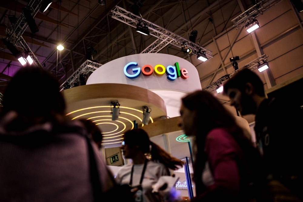 People pass by Google stand during the Web Summit in Lisbon, Portugal, in this Nov. 6, 2019 file photo. — AFP