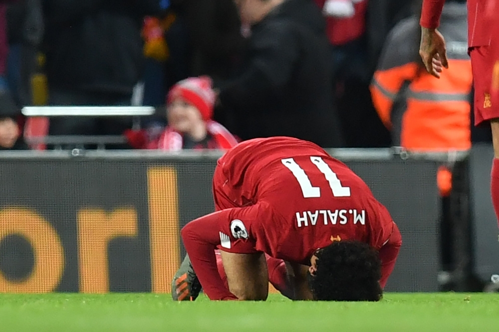 Liverpool's Egyptian midfielder Mohamed Salah celebrates after scoring their second goal during the English Premier League football match against Manchester City at Anfield in Liverpool, northwest England on Nov. 10, 2019. — AFP