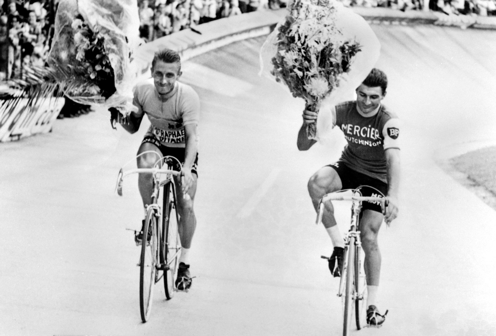 In this file photo taken on Sept. 5, 1978 former French Bicycle racer Raymond Poulidor (R) and François Gadot-Clet, French CEO of Manufrance, French Arms and Cycle Factory of St. Etienne, offer a bike to young girl Christine Donna, in Clermont Ferrand. Poulidor died on Nov. 13, 2019 aged 83, his family announced. — AFP 