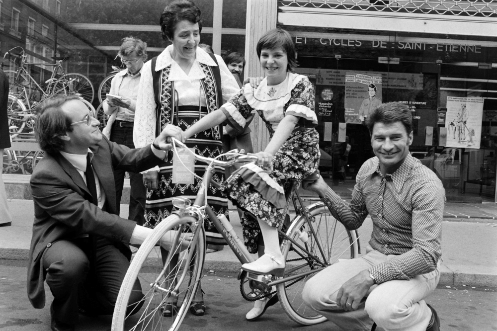 In this file photo taken on Sept. 5, 1978 former French Bicycle racer Raymond Poulidor (R) and François Gadot-Clet, French CEO of Manufrance, French Arms and Cycle Factory of St. Etienne, offer a bike to young girl Christine Donna, in Clermont Ferrand. Poulidor died on Nov. 13, 2019 aged 83, his family announced. — AFP 