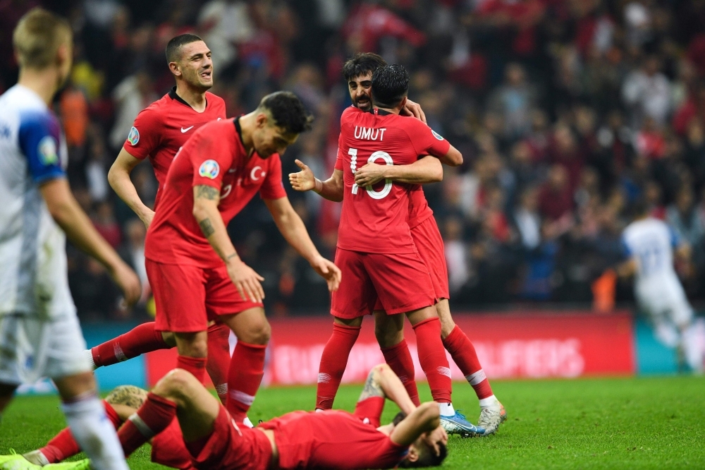 Turkey's team players celebrate after winning the UEFA Euro 2020 qualifying Group H group match between Turkey and Iceland at Turk Telekom Stadium in Istanbul, on Thursday. — AFP