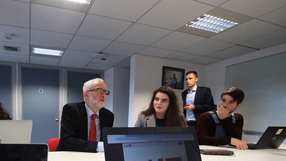 Britain's opposition Labour party leader Jeremy Corbyn talks with students at Lancaster University regarding the party's plans to deliver fast and free full fiber broadband across the country if they win the General Election on Friday. — AFP