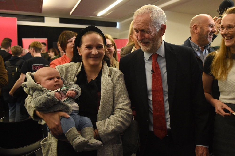 Britain's opposition Labour party leader Jeremy Corbyn talks with students at Lancaster University regarding the party's plans to deliver fast and free full fiber broadband across the country if they win the General Election on Friday. — AFP