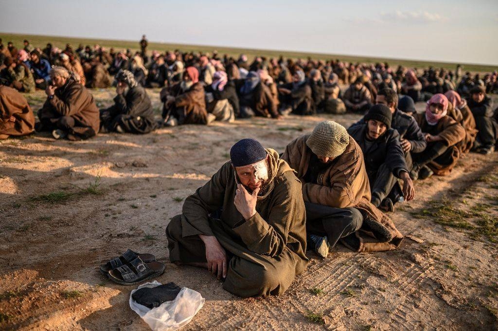 Suspected Daesh (the so-called IS) fighters wait to be searched after leaving the militants' last holdout in eastern Syria in this file photo. — AFP