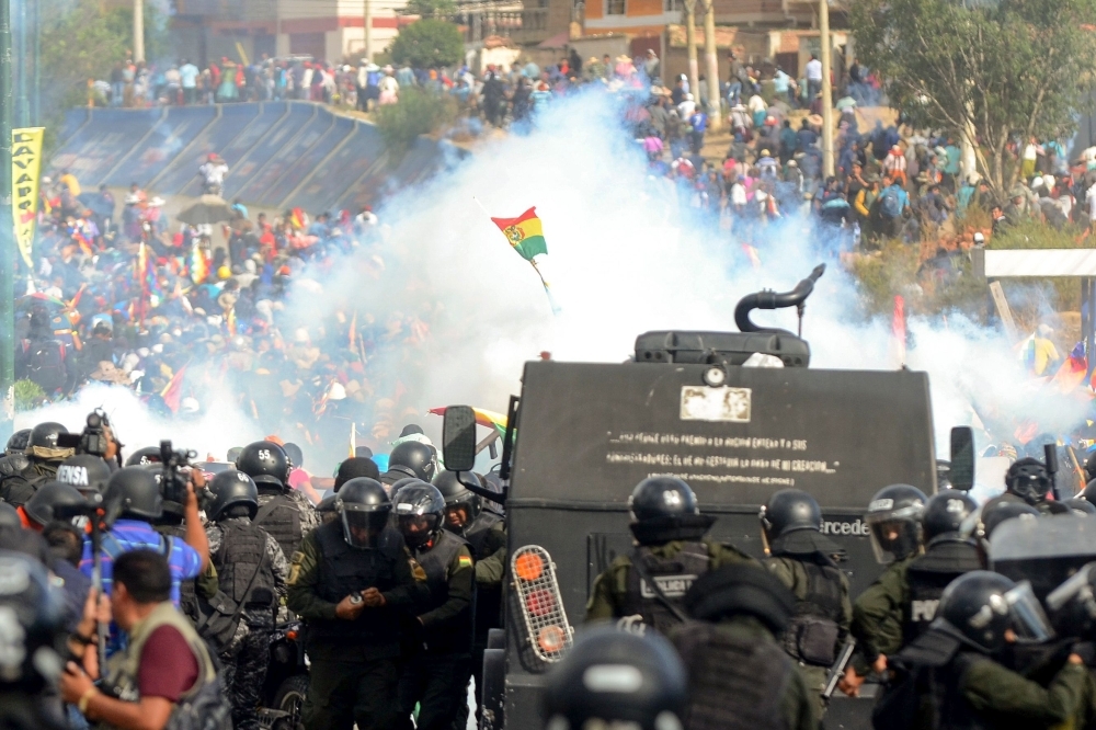 A demonstrator waves a Wiphala flag during a protest against the interim government in La Paz on Friday. -AFP