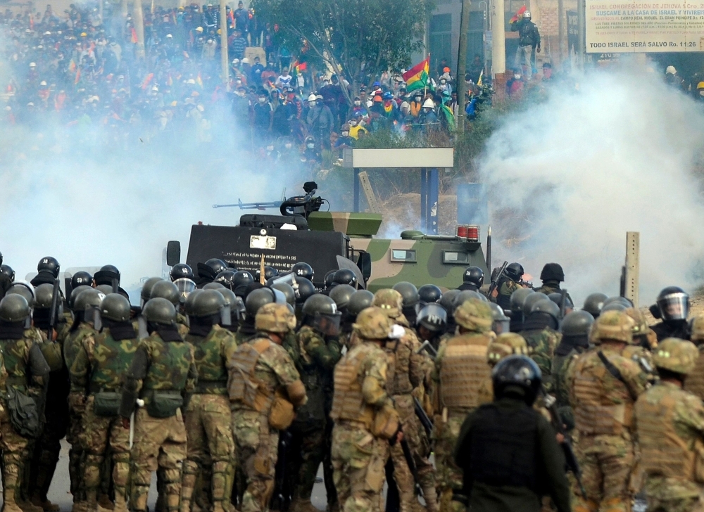 A demonstrator waves a Wiphala flag during a protest against the interim government in La Paz on Friday. -AFP