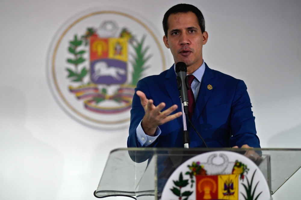 Venezuelan opposition leader and self-proclaimed acting president Juan Guaido speaks during a press conference in Caracas, on Friday. -AFP