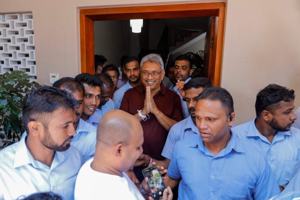  Sri Lanka Podujana Peramuna (SLPP) party presidential candidate Gotabaya Rajapaksa (C) gestures to supporters and well-wishers after his victory outside his house in Colombo on Sunday. -AFP