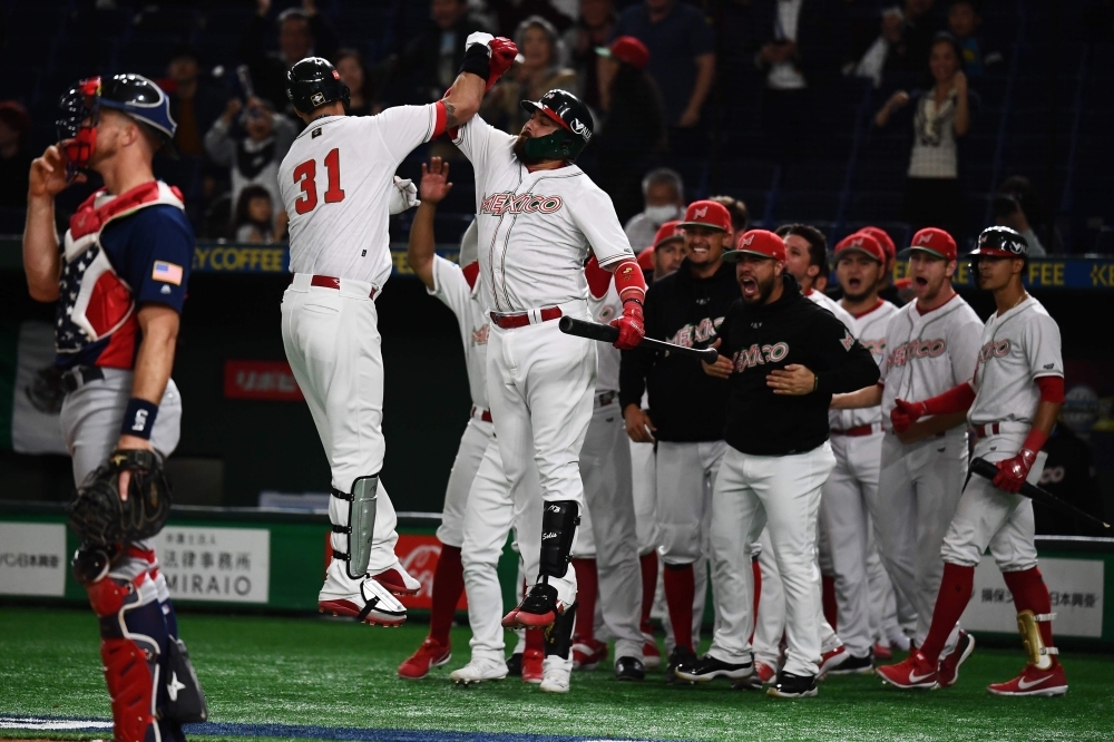Matthew Clark of Mexico (n°31) is congratulated by teammates after a home run during the WBSC Premier 12 Super Round bronze medal baseball game between the USA and Mexico, at the Tokyo Dome in Tokyo, on Sunday. — AFP