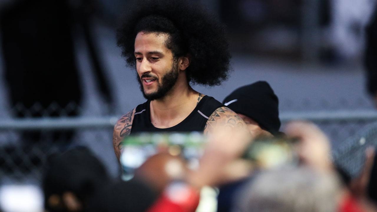 Colin Kaepernick exits the stadium following his NFL workout held at Charles R. Drew High School in Riverdale, Georgia, on Saturday. — AFP