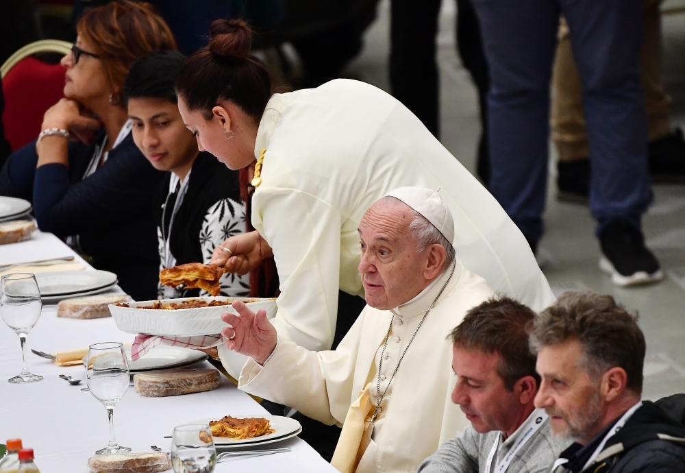 Pope Francis (C) has a lunch with people, on Sunday, at the Paul VI audience hall in Vatican, to mark the World Day of the Poor. — AFP