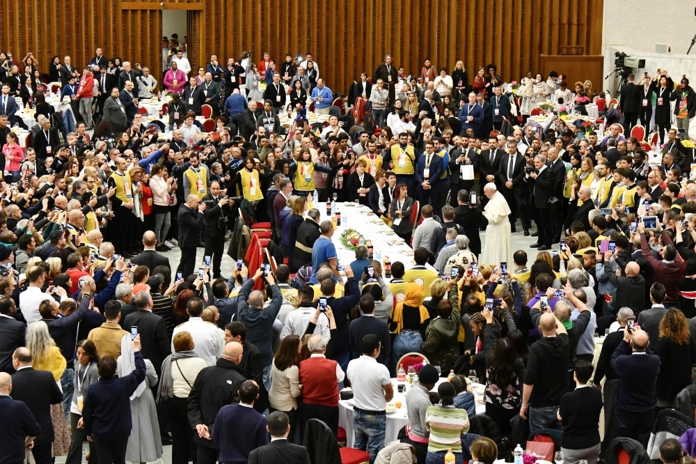 Pope Francis (C) has a lunch with people, on Sunday, at the Paul VI audience hall in Vatican, to mark the World Day of the Poor. — AFP