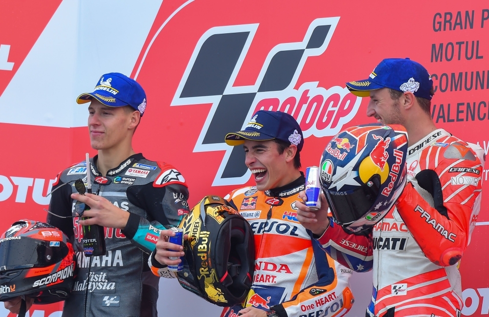 Repsol Honda Team's Spanish rider Marc Marquez celebrates with the trophy on the podium after winning the MotoGP race of the MotoGP Valencia Grand Prix at the Ricardo Tormo racetrack in Cheste near Valencia, on Sunday. World champion Marc Marquez clinched his 12th MotoGP victory of the season in final race in Valencia. — AFP