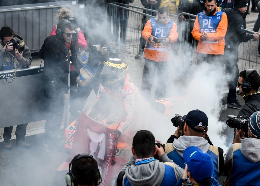 Repsol Honda Team's Spanish rider Marc Marquez celebrates with the trophy on the podium after winning the MotoGP race of the MotoGP Valencia Grand Prix at the Ricardo Tormo racetrack in Cheste near Valencia, on Sunday. World champion Marc Marquez clinched his 12th MotoGP victory of the season in final race in Valencia. — AFP