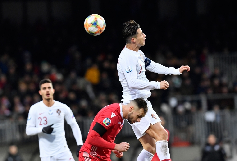 Portugal's forward Cristiano Ronaldo (C) scores a goal during the UEFA Euro 2020 Group B qualification football match between Luxembourg and Portugal at the Josy Barthel Stadium in Luxembourg, on Sunday. — AFP