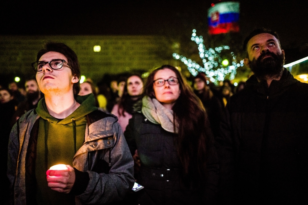  People place candles at a memorial to commemorate the 30th anniversary of the so-called Velvet Revolution on Sunday in Prague. -AFP 