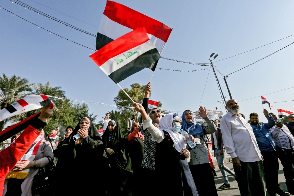 Iraqi protesters march along an avenue near the capital Baghdad's Tahrir Square during ongoing anti-government demonstrations on Sunday. -AFP 