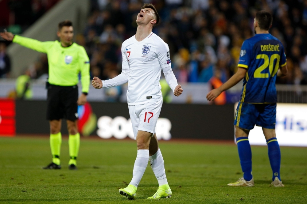 England's Harry Winks (C) celebrates with teammates after scoring a goal during the UEFA Euro 2020 qualifying Group A football match between Kosovo and England in Prishtina on Sunday. — AFP