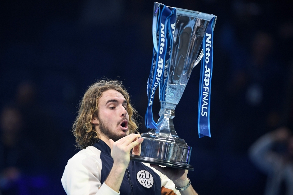 Greece's Stefanos Tsitsipas poses with the winner's trophy after winning the men's singles final match on day eight of the ATP World Tour Finals tennis tournament at the O2 Arena in London on Sunday. Tsitsipas beat Austria's Dominic Thiem to win the match 6-7, 6-2, 7-6. — AFP
