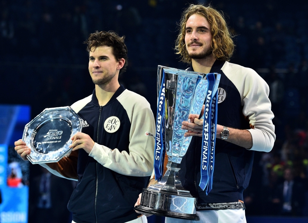 Greece's Stefanos Tsitsipas poses with the winner's trophy after winning the men's singles final match on day eight of the ATP World Tour Finals tennis tournament at the O2 Arena in London on Sunday. Tsitsipas beat Austria's Dominic Thiem to win the match 6-7, 6-2, 7-6. — AFP