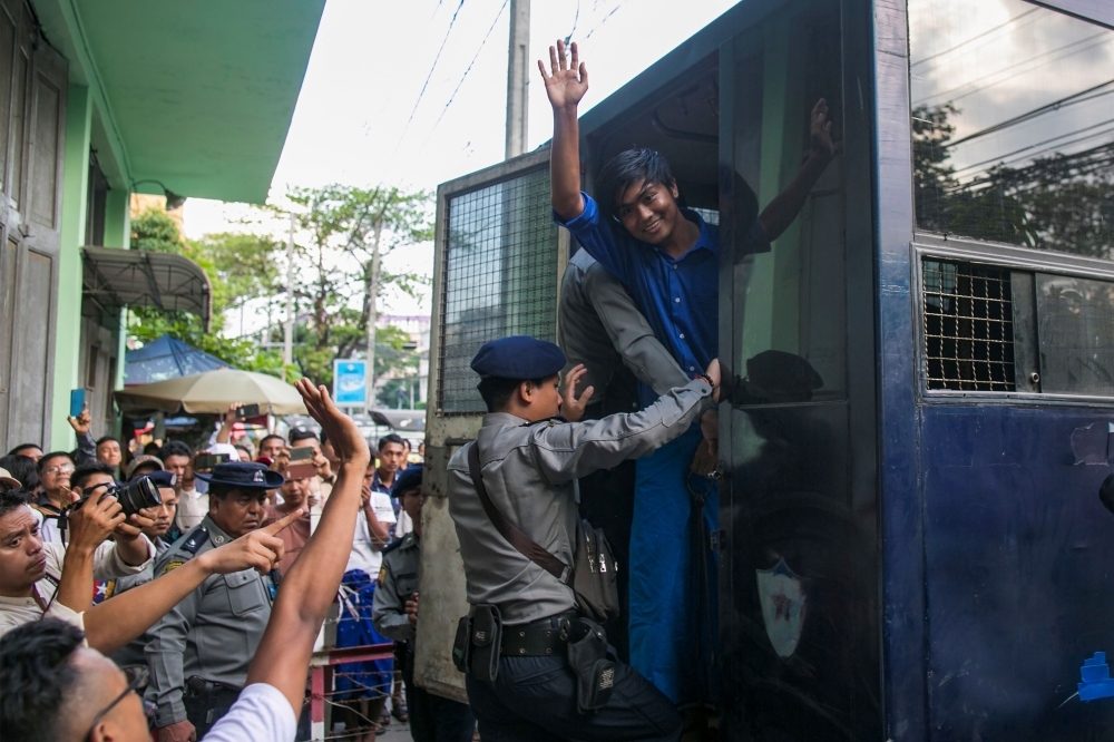 Kay Khaing Tun, a performer of Peacock Generation group, speaks to journalists peak after a trial in Yangon on Monday. — AFP