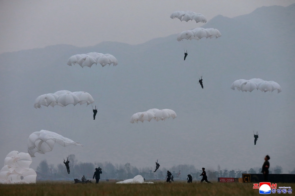 Members of the Air and Anti-Aircraft Force of the Korean People's Army are seen parachuting during airborne insertion training at an undisclosed location. — AFP