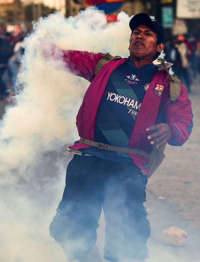 Supporters of Bolivian ex-President Evo Morales shout slogans during a demonstration in Cochabamba, on Monday. -AFP