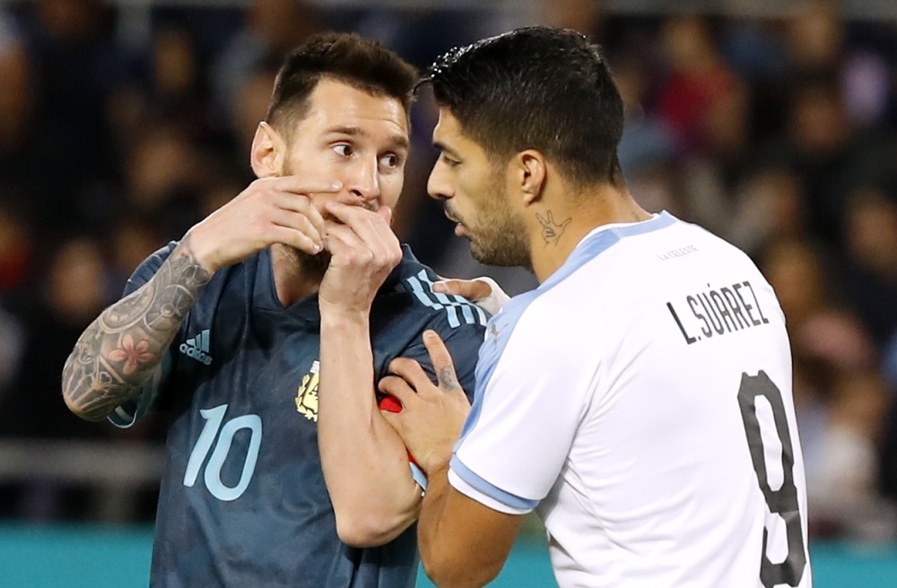 Argentina's forward Lionel Messi (L) dribbles a ball while warming up ahead of the friendly football match between Argentina and Uruguay at the Bloomfield stadium in the Israeli coastal city of Tel Aviv on Monday. — AFP