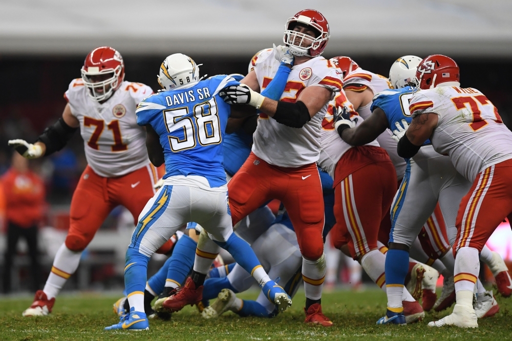 Charger defender Thomas Davis crashes with Chiefs players during the 2019 NFL week 11 regular season football game between Kansas City Chiefs and Los Angeles Chargers at the Azteca Stadium in Mexico City on Monday. — AFP