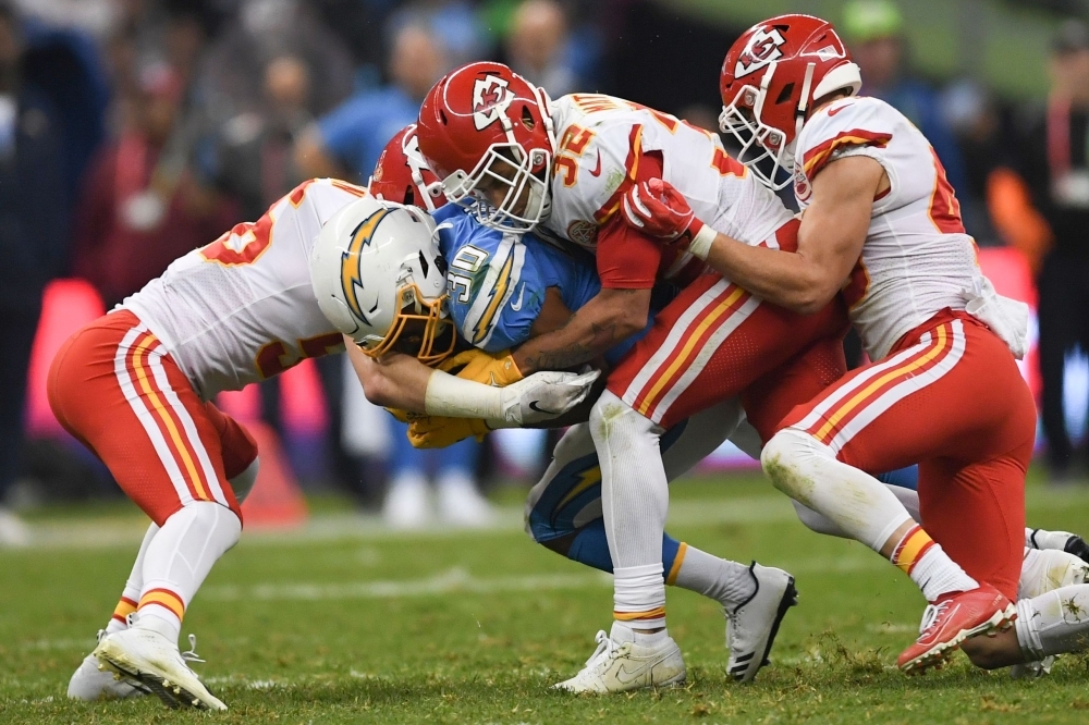 Charger defender Thomas Davis crashes with Chiefs players during the 2019 NFL week 11 regular season football game between Kansas City Chiefs and Los Angeles Chargers at the Azteca Stadium in Mexico City on Monday. — AFP