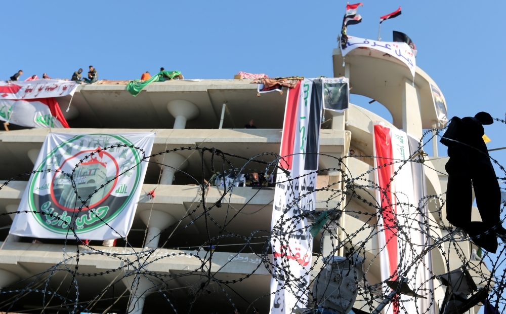 Iraqi anti-government protesters are pictured at Tahrir square on Tuesday. — AFP