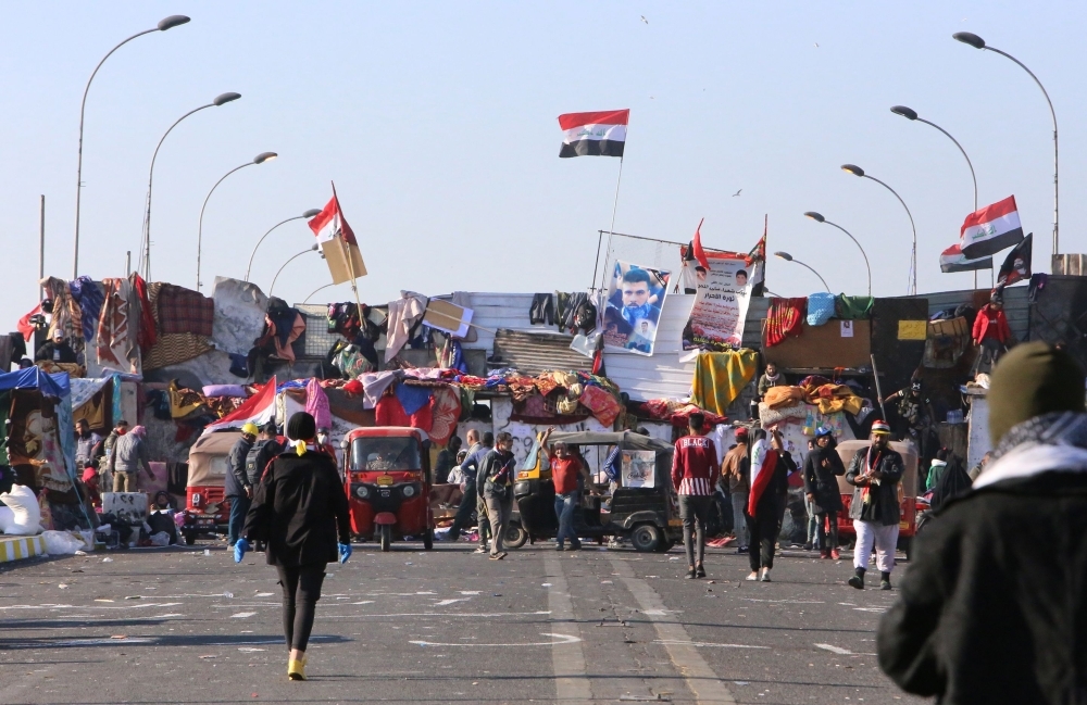Iraqi anti-government protesters are pictured at Tahrir square on Tuesday. — AFP