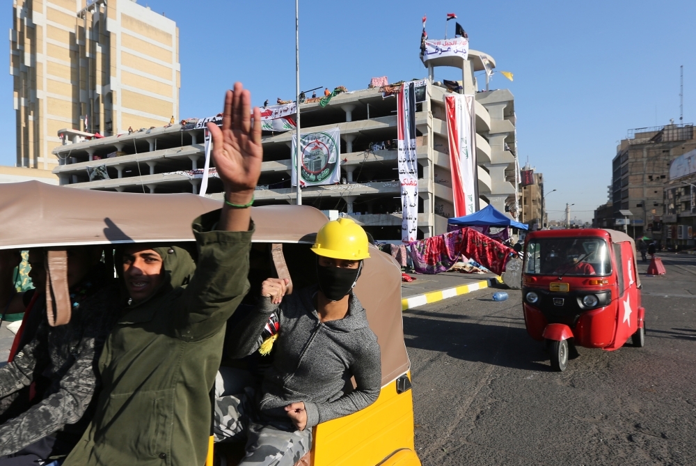 Iraqi anti-government protesters are pictured at Tahrir square on Tuesday. — AFP