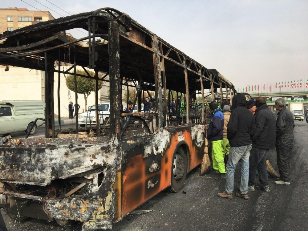 Iranians inspect the wreckage of a bus that was set ablaze by protesters during a demonstration against a rise in gasoline prices in the central city of Isfahan in this Nov. 17, 2019 file photo. — AFP