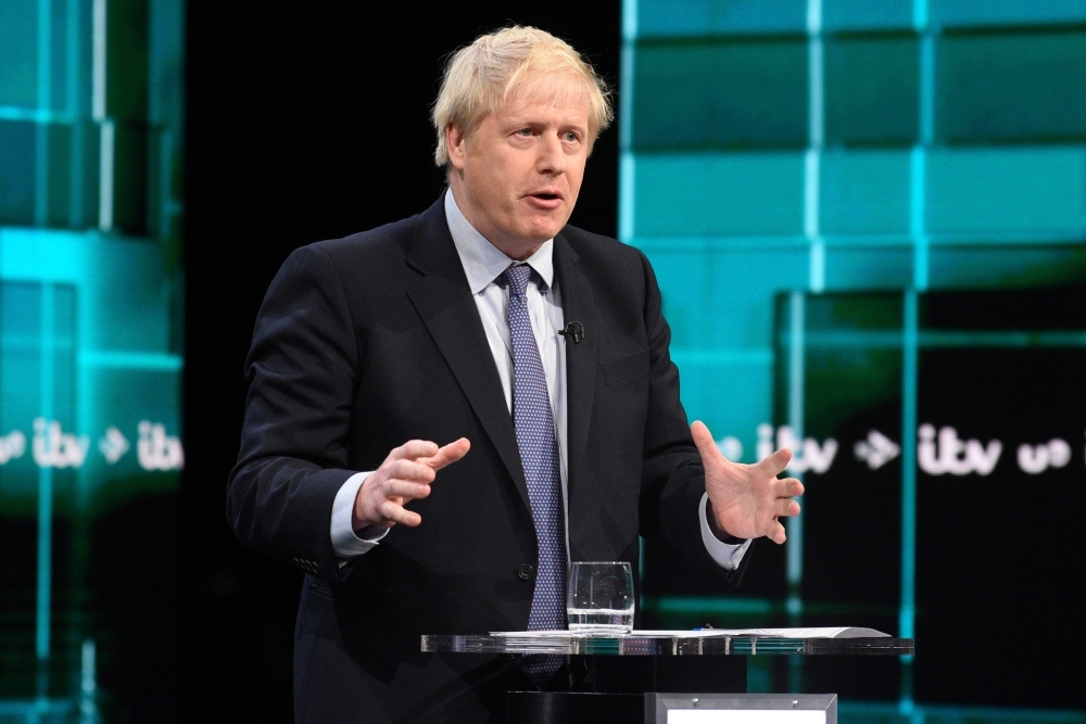 Britain's Prime Minister Boris Johnson (L) and Britain's Labour Party leader Jeremy Corbyn (R) debate on the set of 