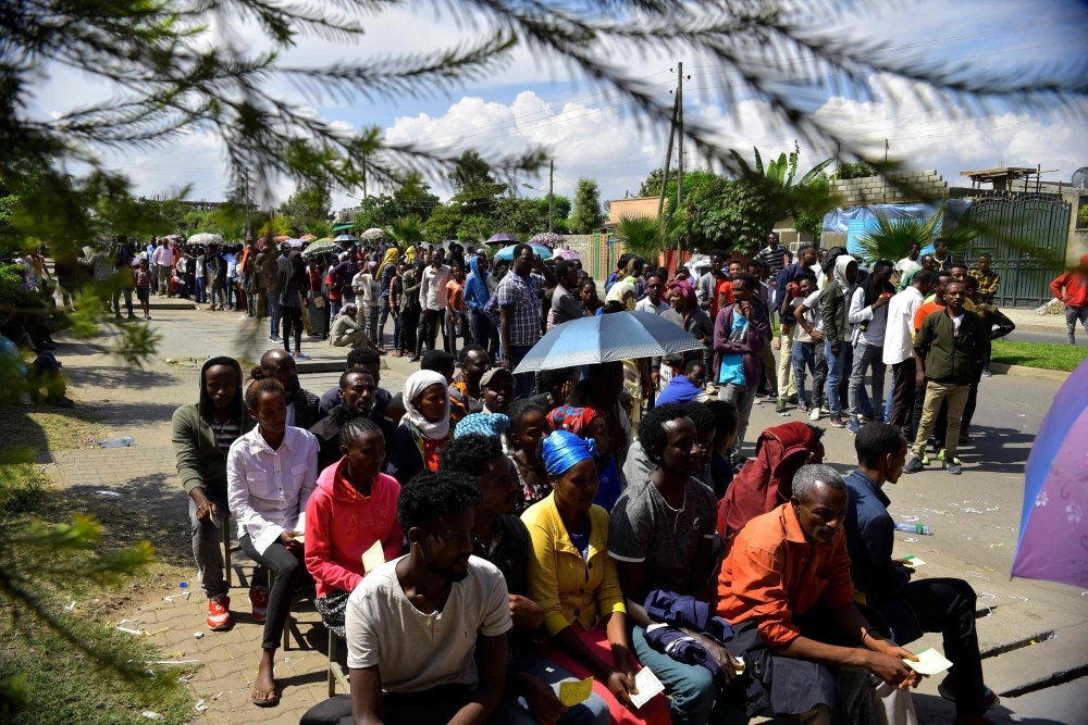 Voters pose for a picture with their identity documents while waiting in a queue to cast their vote during the Sidama referendum in Hawassa, Ethiopia, on Wednesday. — AFP