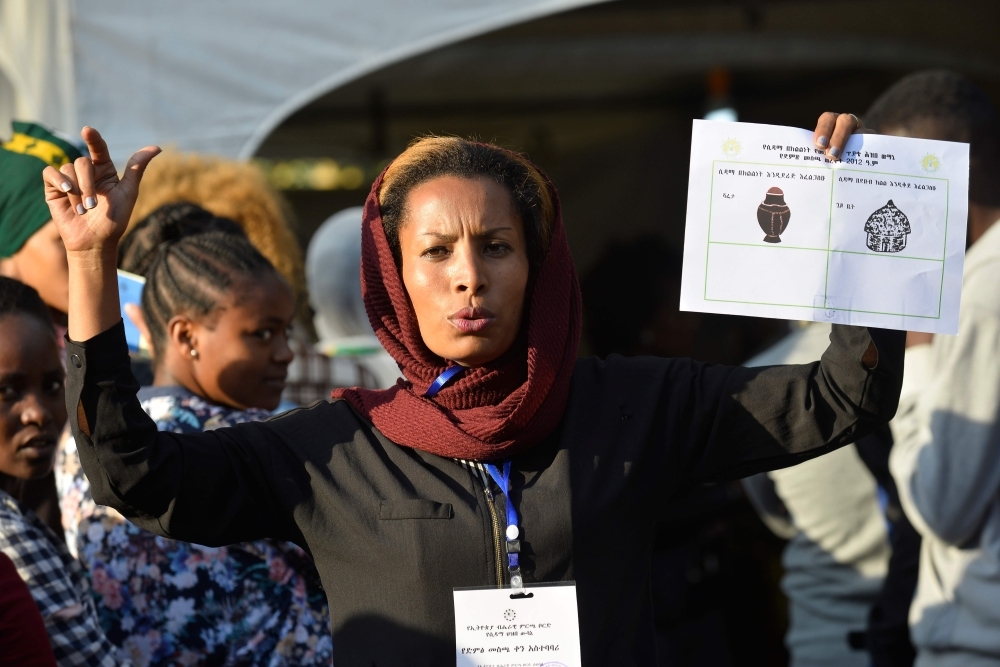 Voters pose for a picture with their identity documents while waiting in a queue to cast their vote during the Sidama referendum in Hawassa, Ethiopia, on Wednesday. — AFP