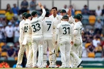 Australia team celebrates with Michael Starc, who helped his team seize the advantage on the opening day of the first Test against Pakistan at the Gabba in Brisbane on Thursday.