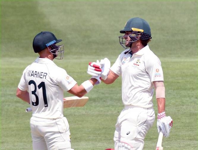 Australian opening pair David Warner and Joe Burns share a 222-run stand in the first Test against Pakidan in Brisbane on Friday.