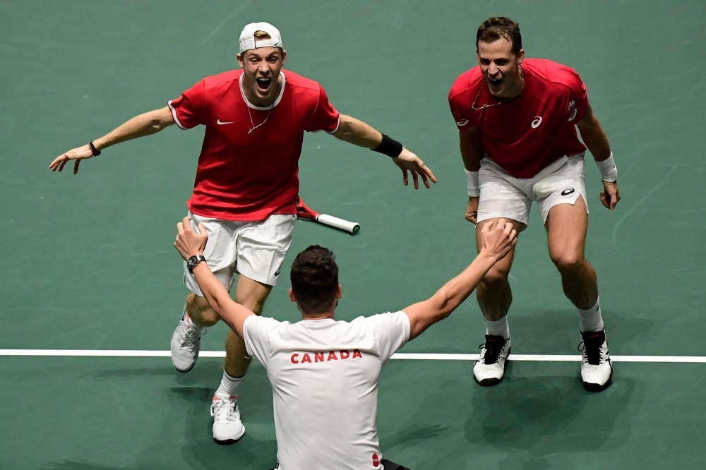 Canada's Vasek Pospisil (R) and Denis Shapovalov celebrate with Canada's captain Frank Dancevic (C) after winning a quarterfinal doubles tennis match against Australia at the Davis Cup Madrid Finals 2019 in Madrid on Thursday. — AFP